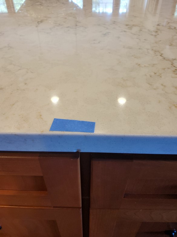 A before picture from a recent quartz countertop chip repair in the South Sound area