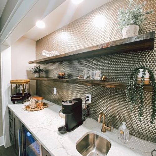 White quartz kitchen countertop with metallic tile penny backsplash