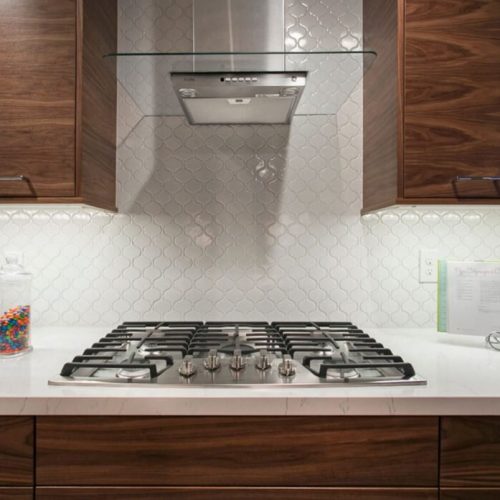 Chefs Kitchen, White Quartz Countertop w/ natural wood cabinets.