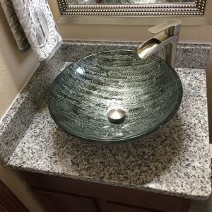 A vessel sink which sits on top of the countertop
